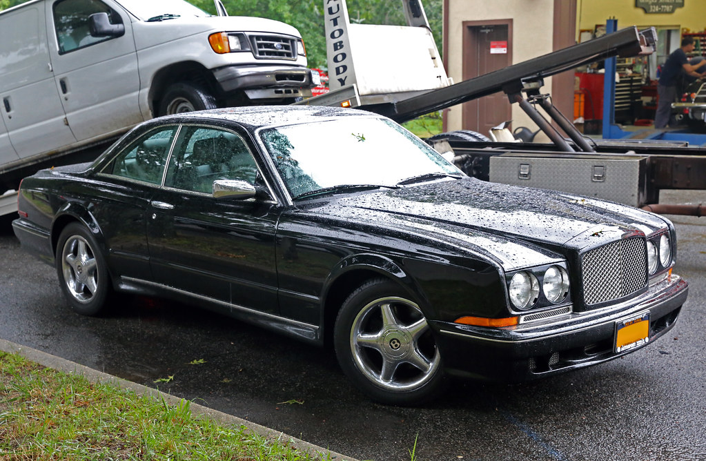 Professional emergency towing recovery with certified flatbed tow truck safely transporting vehicle